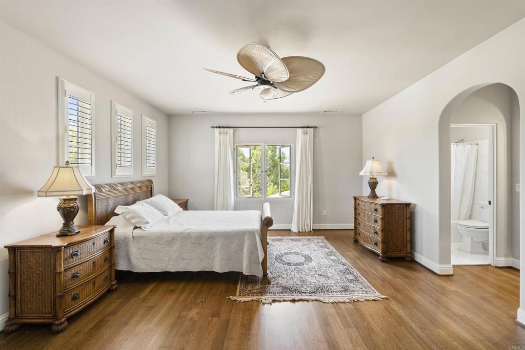 16733 Calle Hermosa San Diego, CA 92127 - Photo 33 of 43 a bedroom with a bed and wooden floor