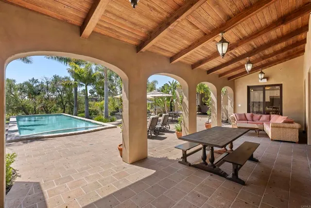 a view of a patio with dining table and chairs