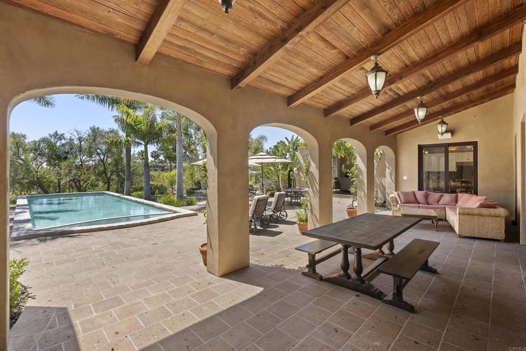 16733 Calle Hermosa San Diego, CA 92127 - Photo 35 of 43 a view of a patio with dining table and chairs