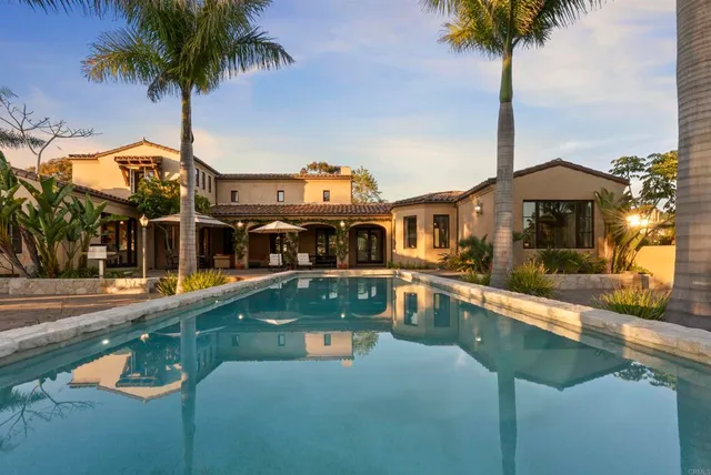 an outdoor space with swimming pool and furniture