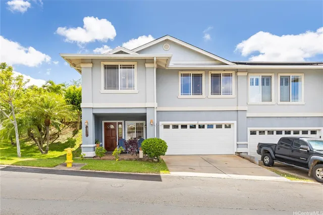 a front view of a house with a garden and plants