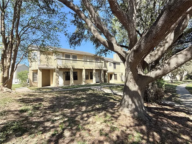 a view of a large building with large trees