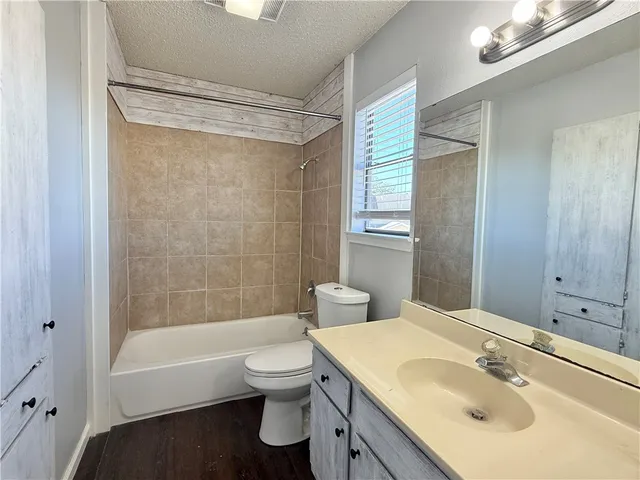 a view of room with walk in closet and wooden floor