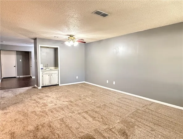 an empty room with wooden floor and a window