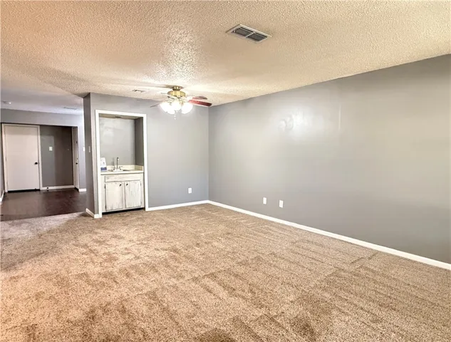 an empty room with wooden floor and a window