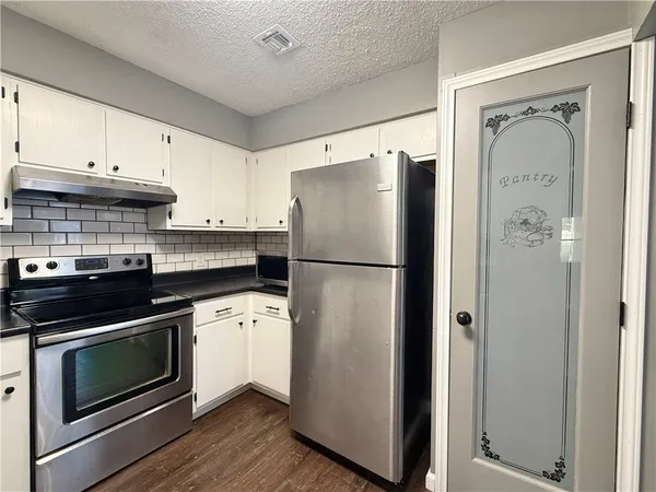 an empty room with a window and ceiling fan