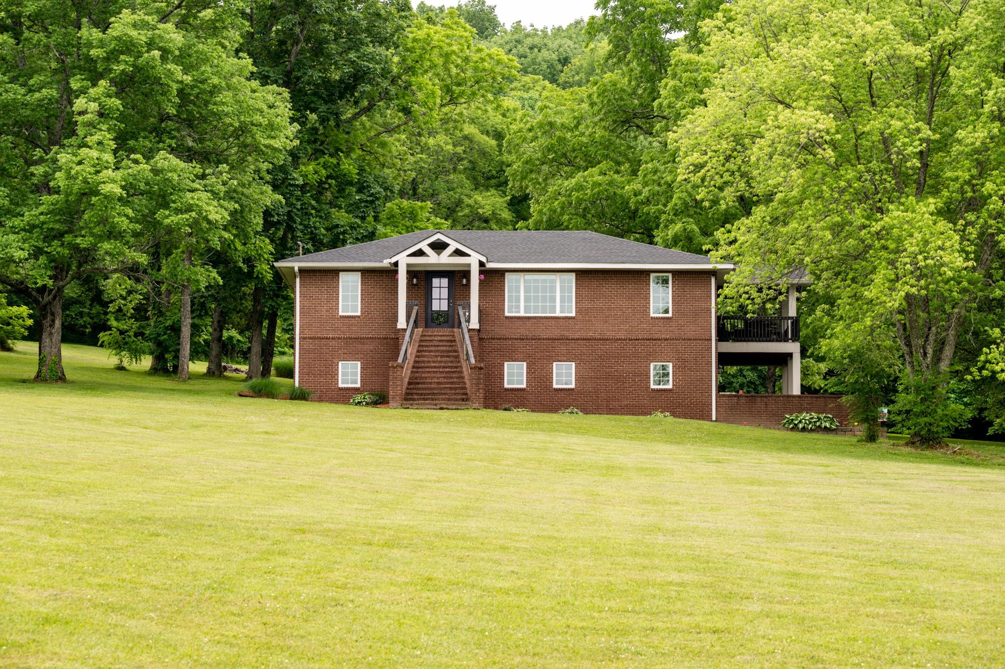 5252 Cainsville Road Lebanon, TN 37090 - Photo 1 of 45 a front view of a house with a garden