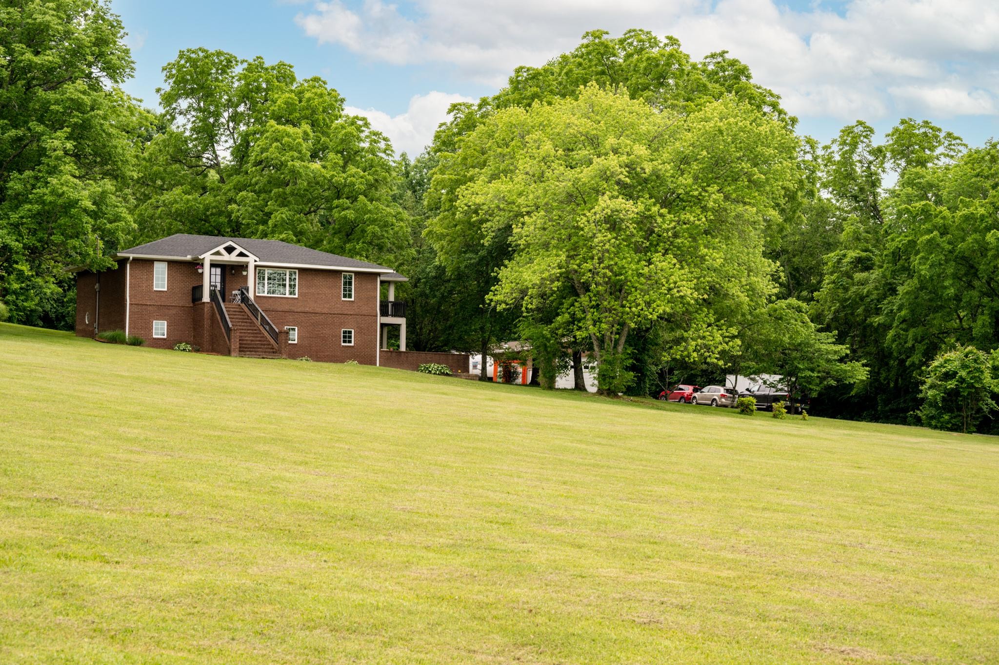5252 Cainsville Road Lebanon, TN 37090 - Photo 2 of 45 a swimming pool with trees in front of it