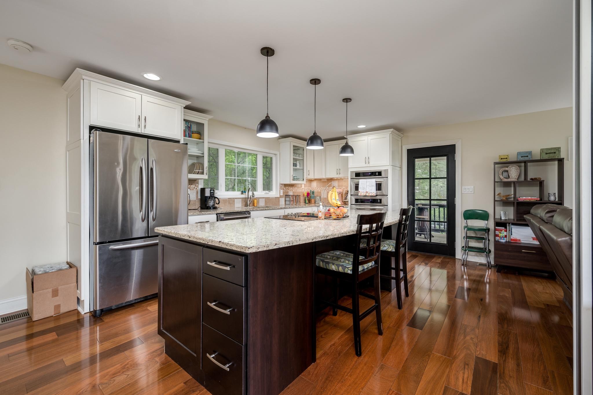 5252 Cainsville Road Lebanon, TN 37090 - Photo 12 of 45 a kitchen with stainless steel appliances granite countertop a refrigerator a sink dishwasher a stove and a dining table with wooden floor