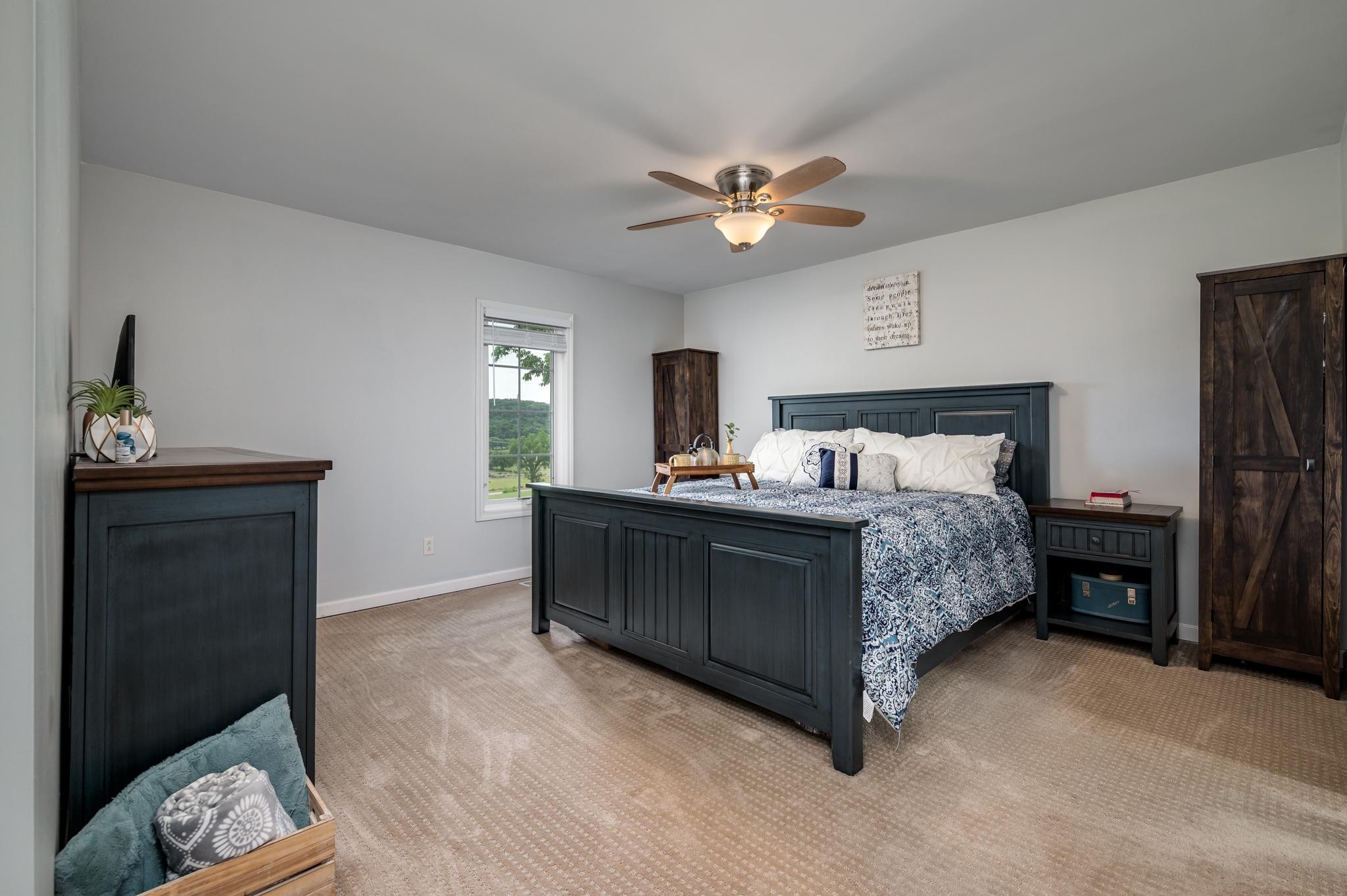 5252 Cainsville Road Lebanon, TN 37090 - Photo 18 of 45 a bedroom with a bed and a chandelier
