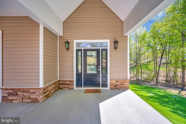 a large kitchen with stainless steel appliances kitchen island granite countertop a stove a sink and a refrigerator