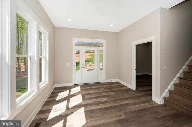 a kitchen with granite countertop white cabinets and stainless steel appliances