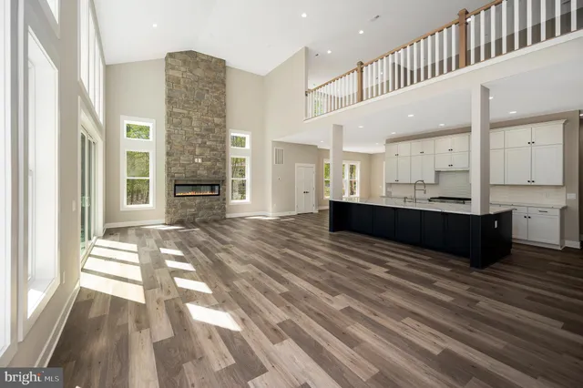 a spacious bathroom with a double vanity sink toilet mirror and bathtub