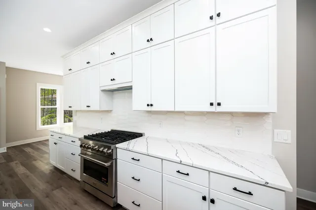 a large kitchen with a large counter top and sink