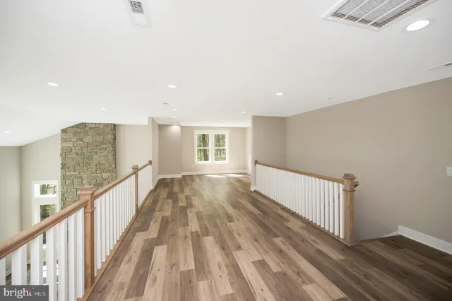 a view of a house with a big yard and large trees