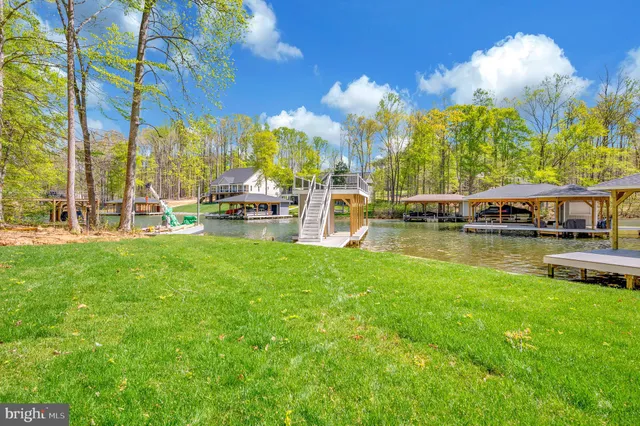 a view of house with a yard and deck