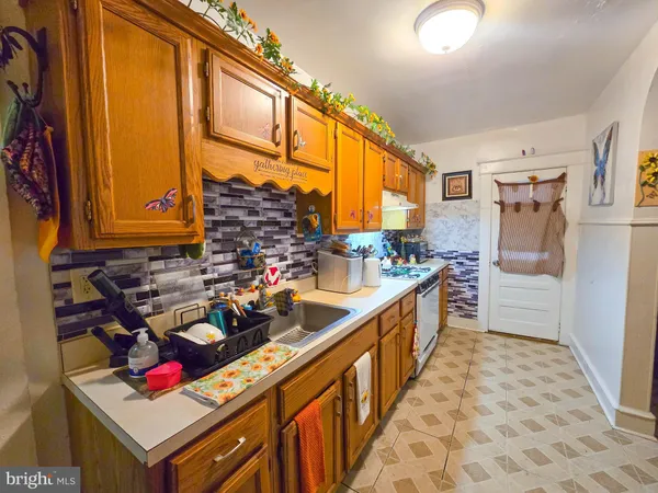 a kitchen with stainless steel appliances granite countertop a stove and cabinets