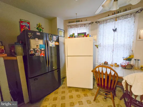 a refrigerator and a table in a kitchen