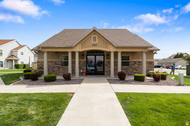 482 South 2500th West, Unit 2 Springville, UT 84663 - Photo 34 of 52 Building facade with stone accents, stucco finish, a covered entry, and decorative pillars