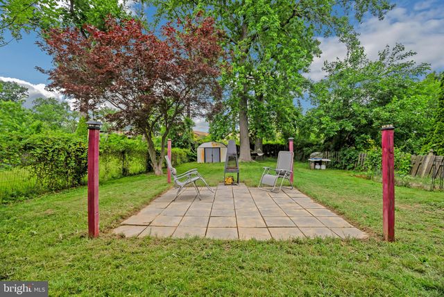 a view of a house with a backyard porch and sitting area