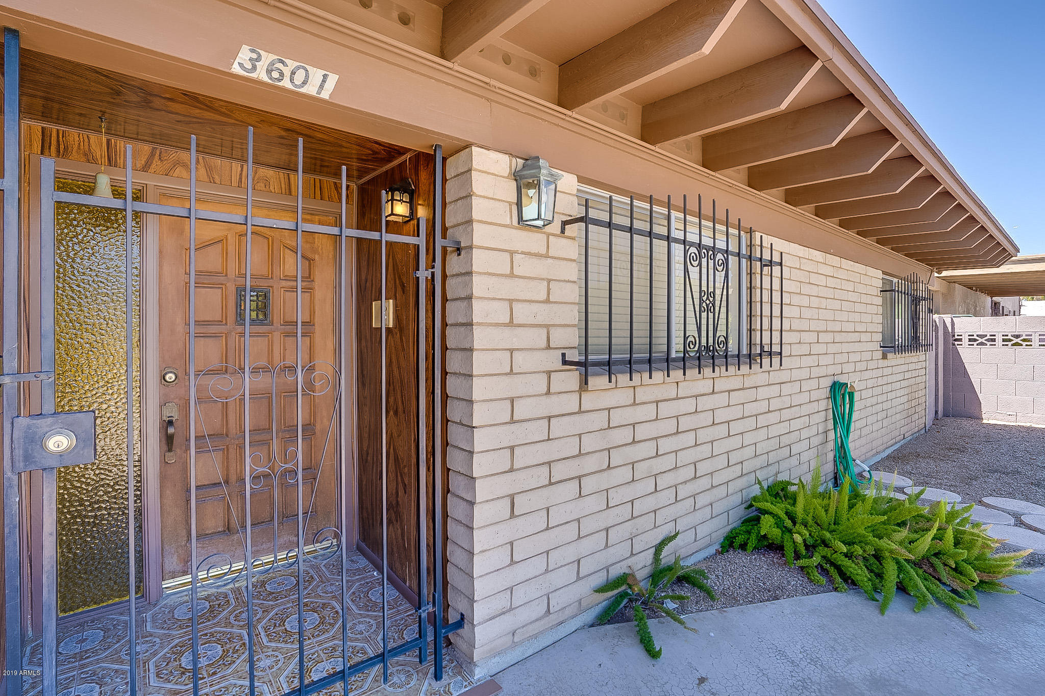 3601 West Griswold Road Phoenix, AZ 85051 - Photo 4 of 40 a view of a door and chair in the patio