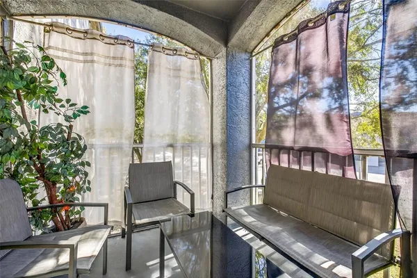 a outdoor living room with furniture and a potted plant
