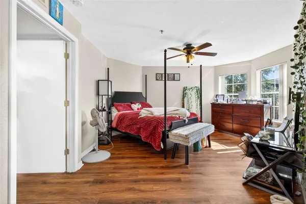 a bedroom with a bed and wooden floor