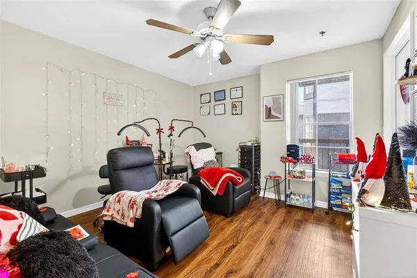 a living room with furniture and a wooden floor