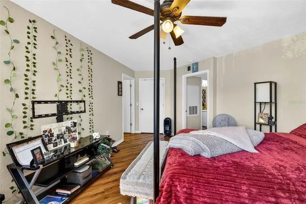 a bedroom with a bed and wooden floor