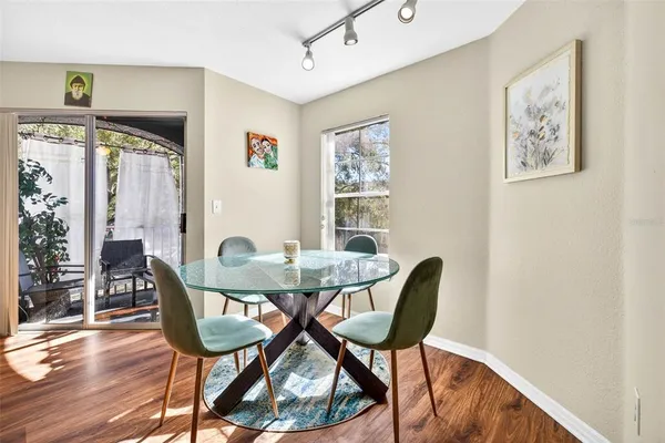 a view of a dining room with furniture and wooden floor