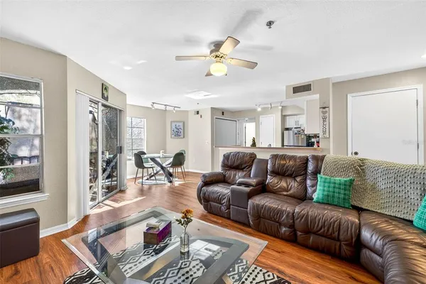 a living room with furniture and wooden floor