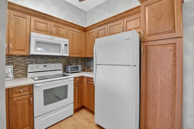 a white refrigerator freezer and a stove top oven