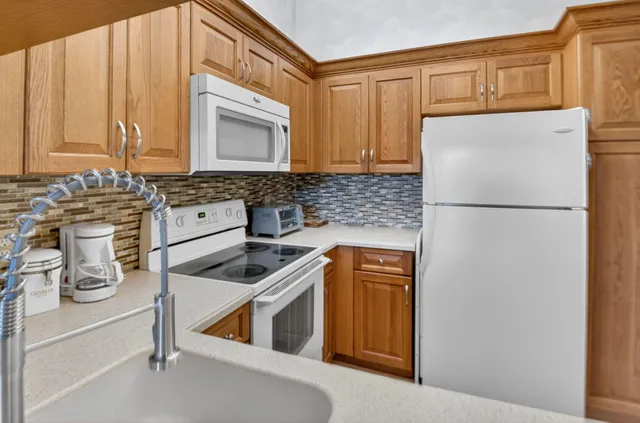 a kitchen with a refrigerator and a sink