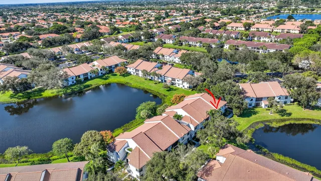 an aerial view of residential houses with outdoor space and lake view