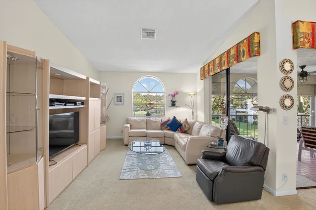 a living room with furniture and a floor to ceiling window