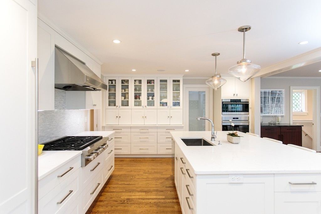 134 Edmunds Road Wellesley, MA 02481 - Photo 8 of 29 a kitchen that has a lot of white cabinets and stainless steel appliances