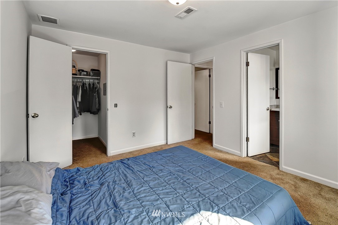 22119 Meridian Avenue South Bothell, WA 98021 - Photo 13 of 17 a bedroom with a bed and wooden floor