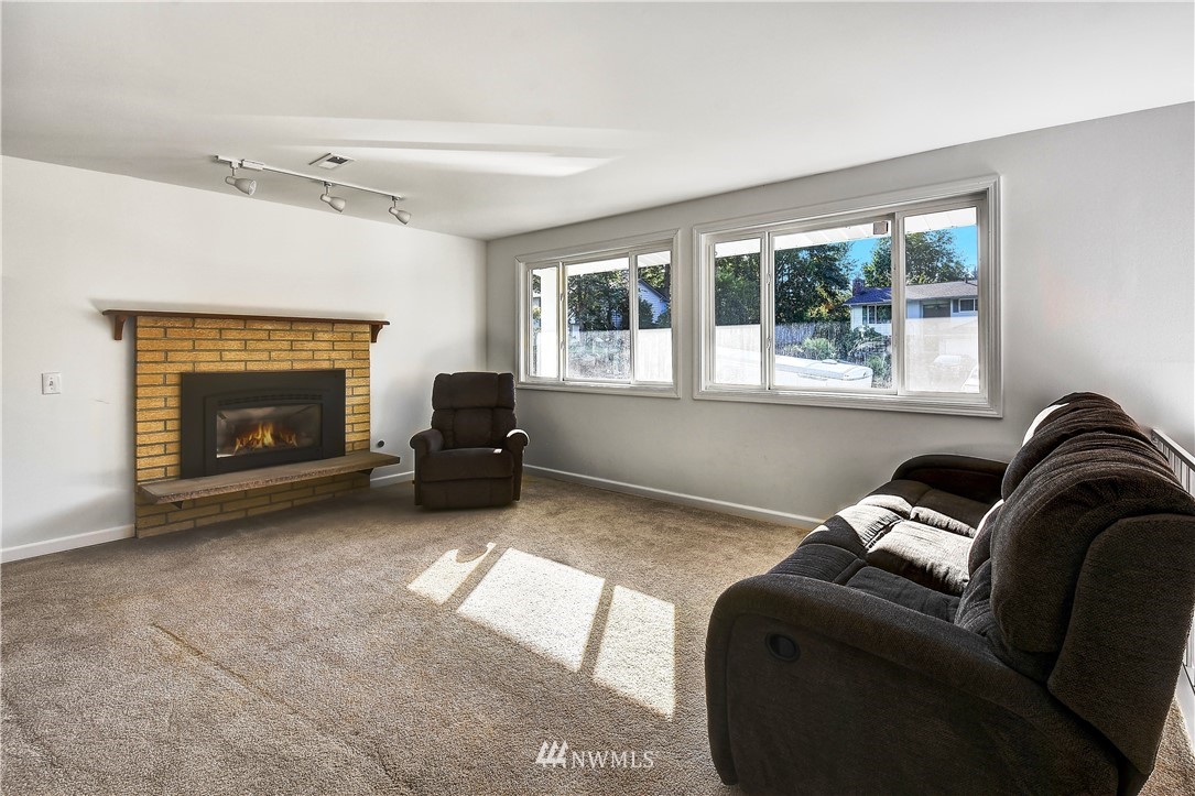 22119 Meridian Avenue South Bothell, WA 98021 - Photo 6 of 17 a living room with furniture a window and a fireplace