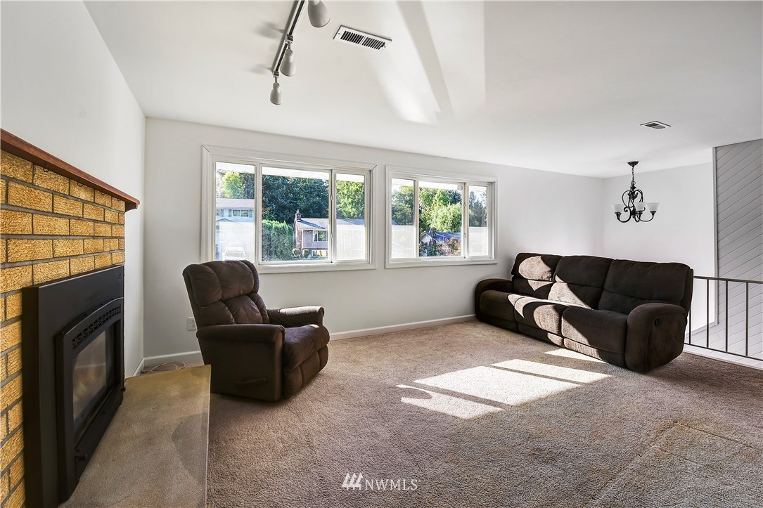 22119 Meridian Avenue South Bothell, WA 98021 - Photo 7 of 17 a living room with furniture a window and a fireplace