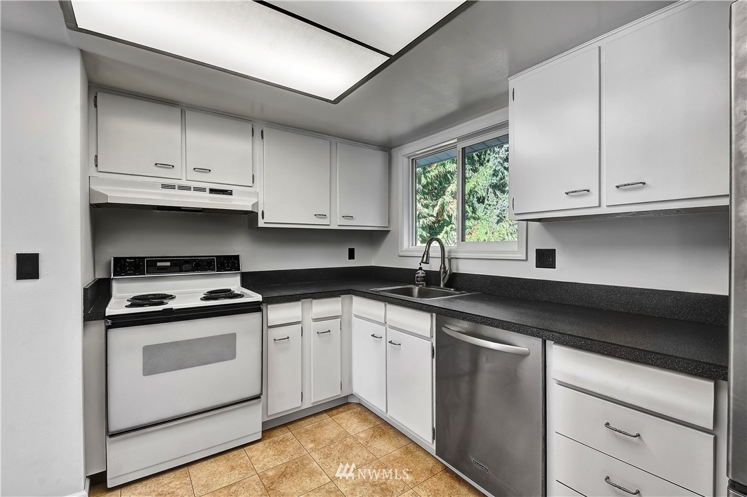 22119 Meridian Avenue South Bothell, WA 98021 - Photo 9 of 17 a kitchen with granite countertop cabinets stainless steel appliances and a sink
