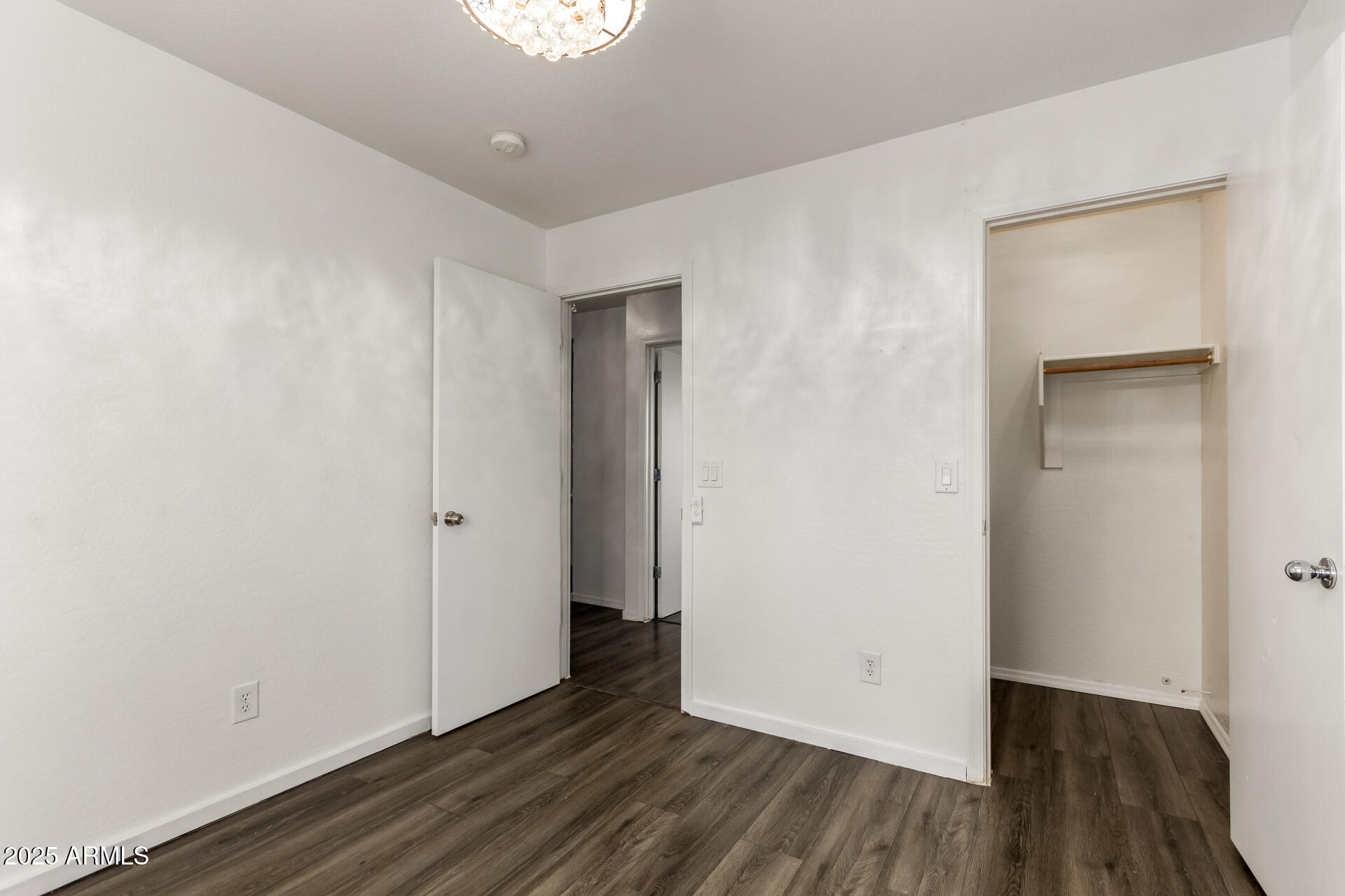 2507 West Desert Spring Way San Tan Valley, AZ 85144 - Photo 12 of 24 a view of an empty room with wooden floor and closet