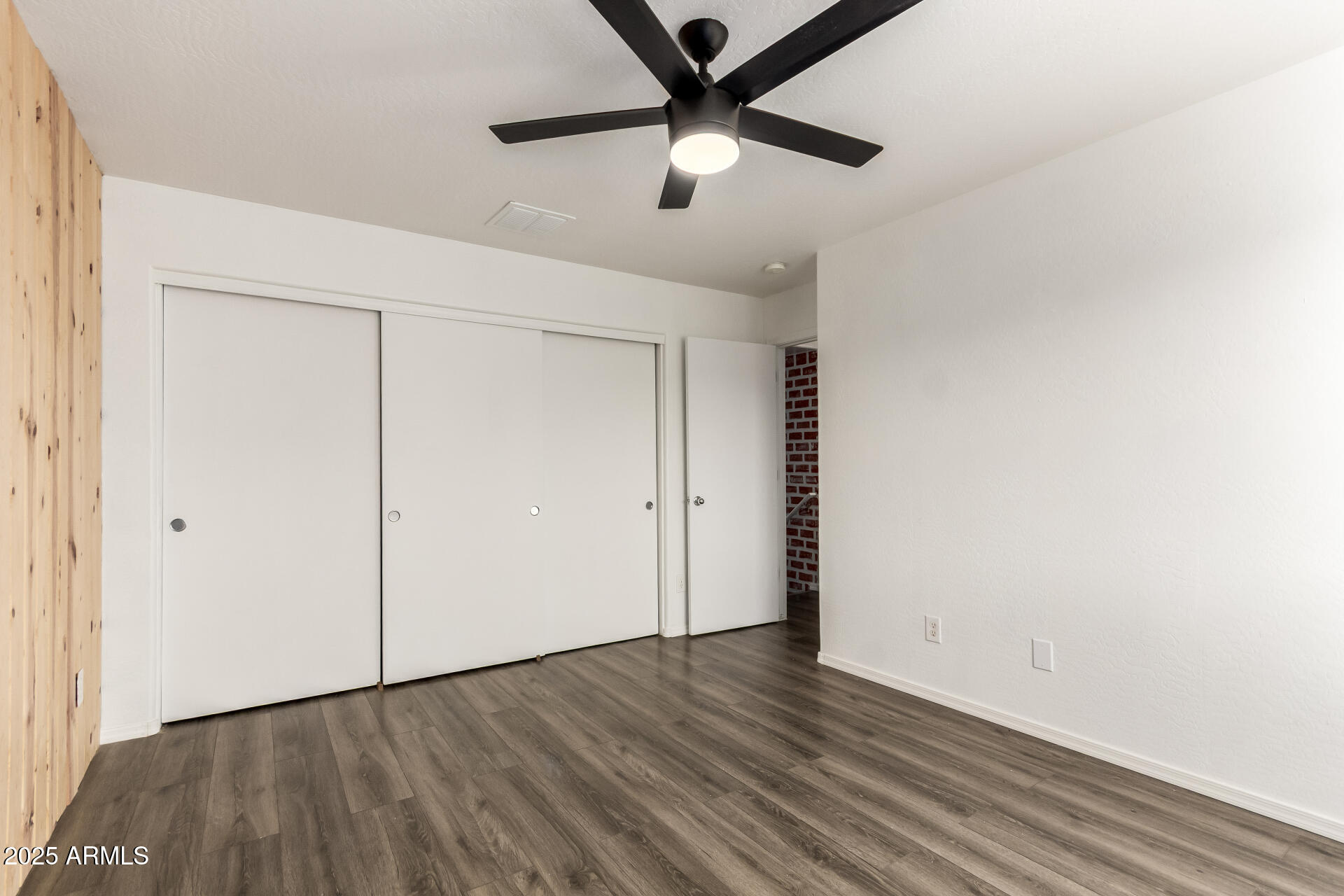 2507 West Desert Spring Way San Tan Valley, AZ 85144 - Photo 15 of 24 a view of an empty room with wooden floor