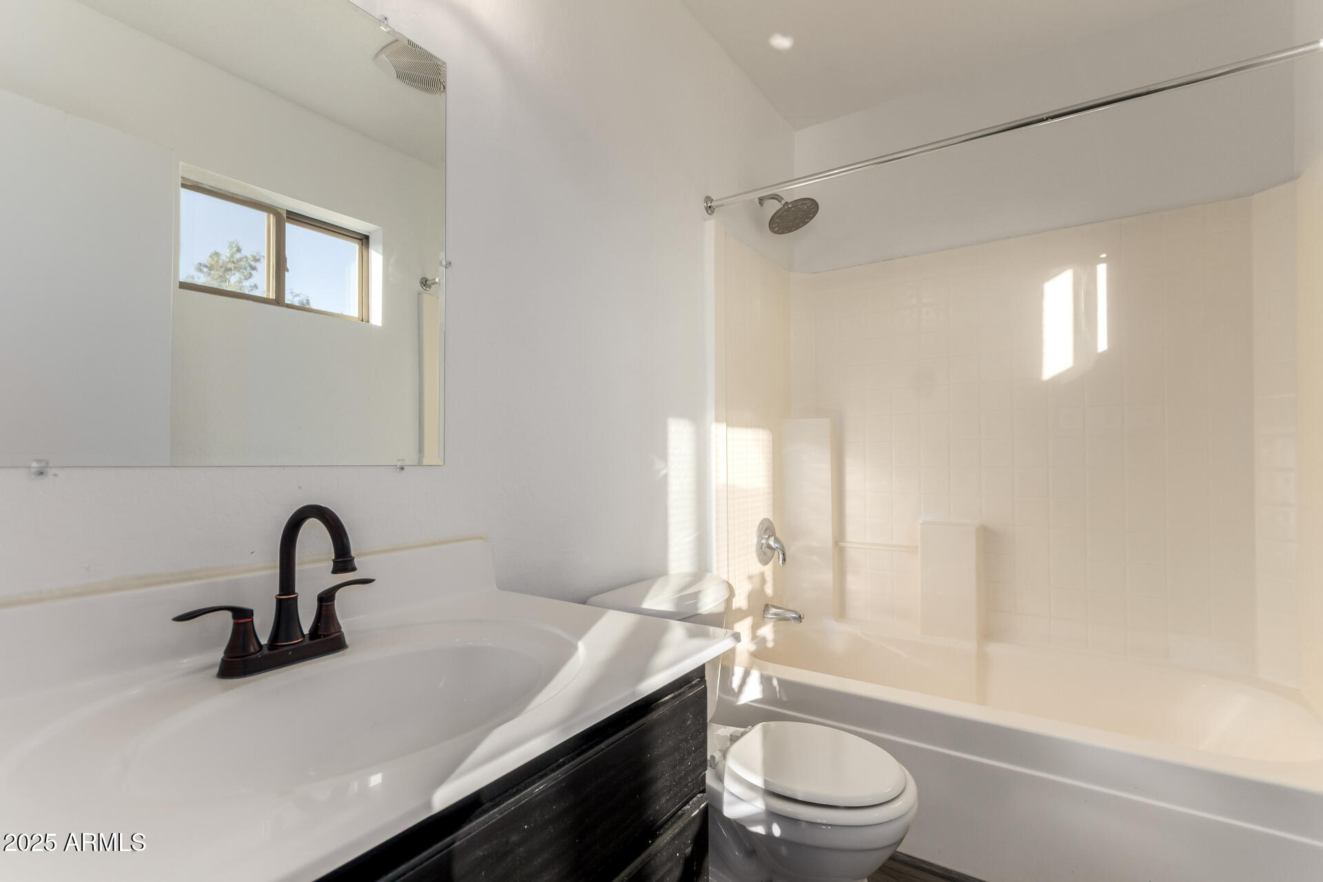 2507 West Desert Spring Way San Tan Valley, AZ 85144 - Photo 16 of 24 a bathroom with a sink a toilet and a window