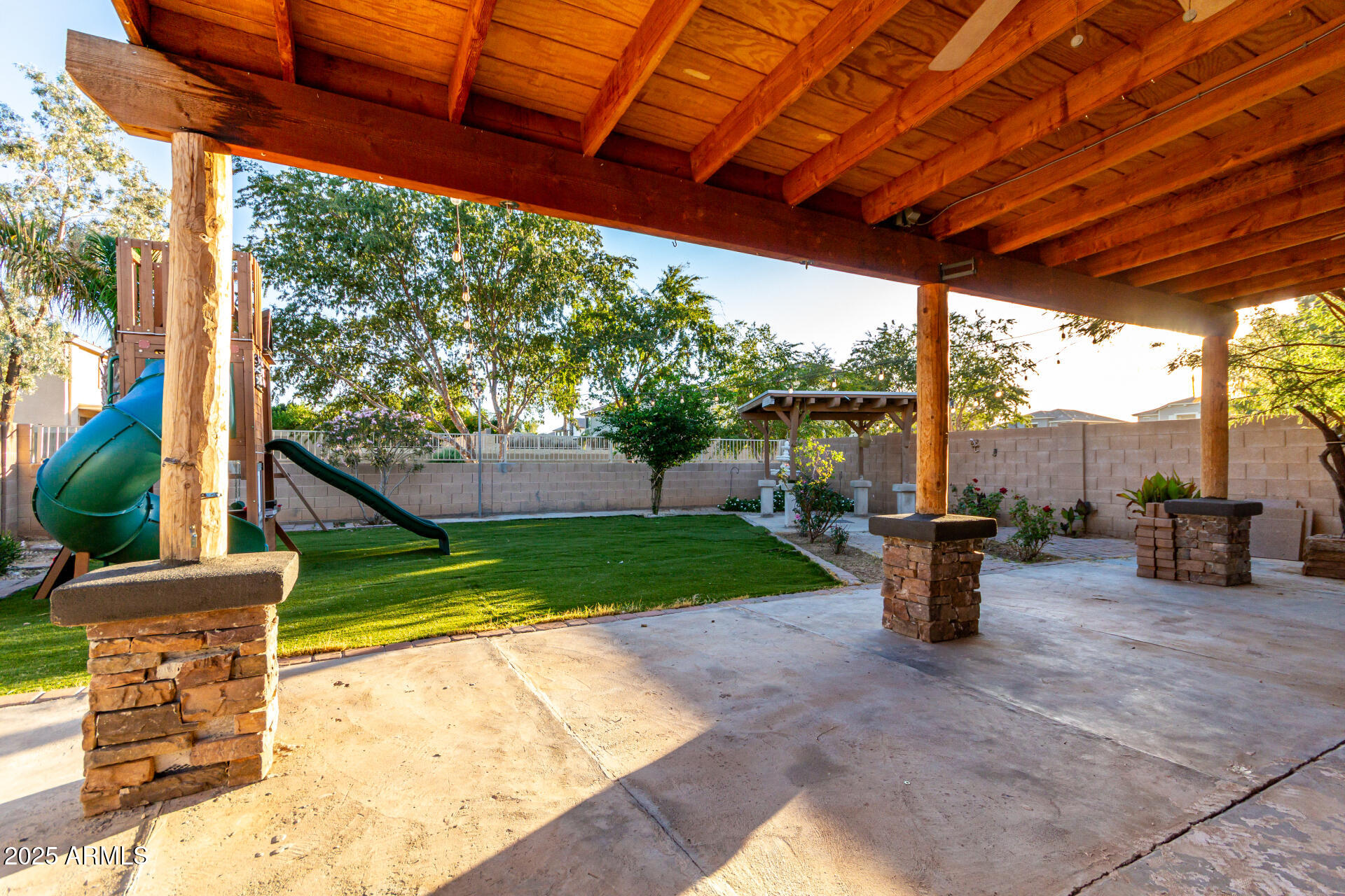 2507 West Desert Spring Way San Tan Valley, AZ 85144 - Photo 23 of 24 a view of a porch with furniture and a backyard
