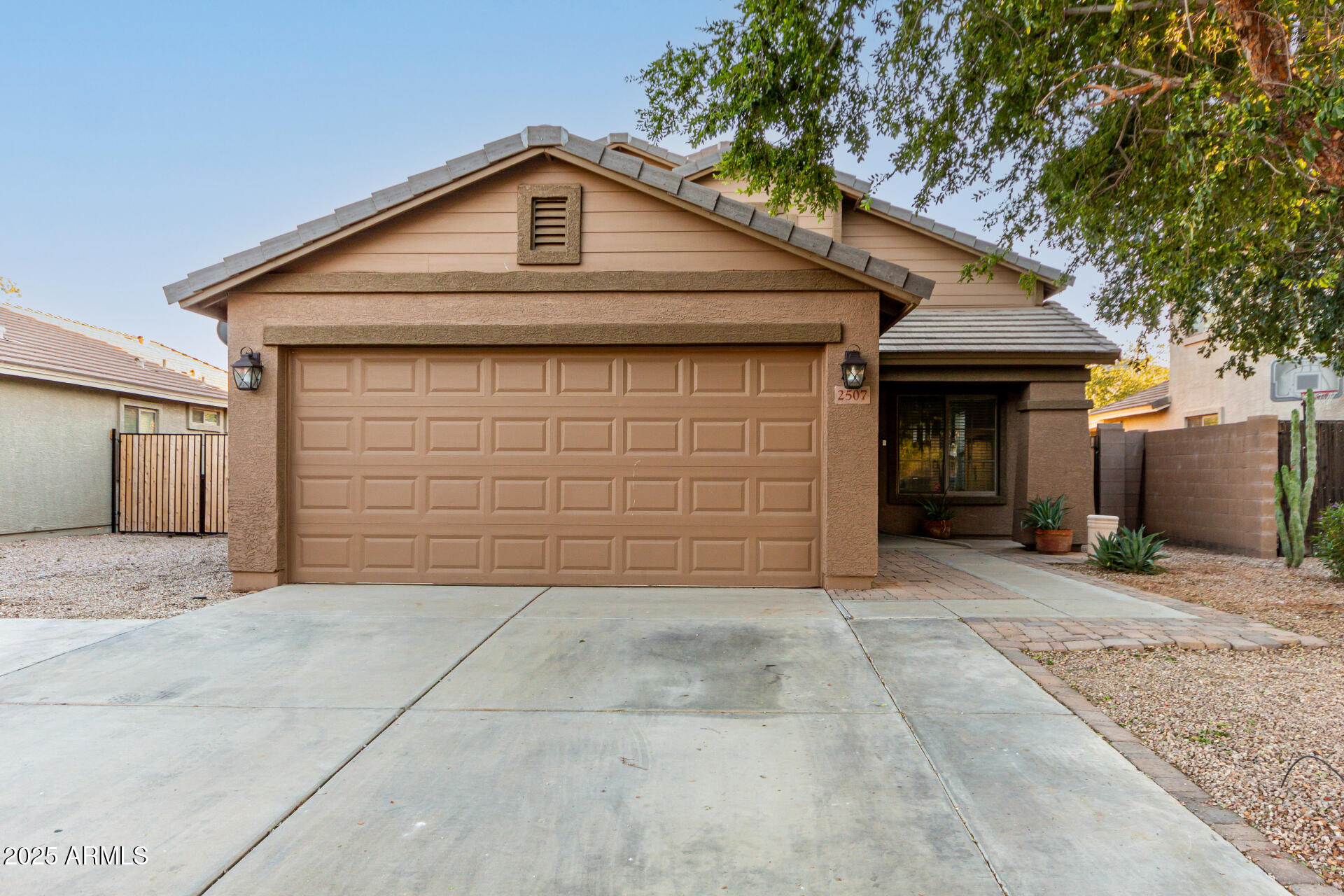 2507 West Desert Spring Way San Tan Valley, AZ 85144 - Photo 3 of 24 a front view of a house with a garage