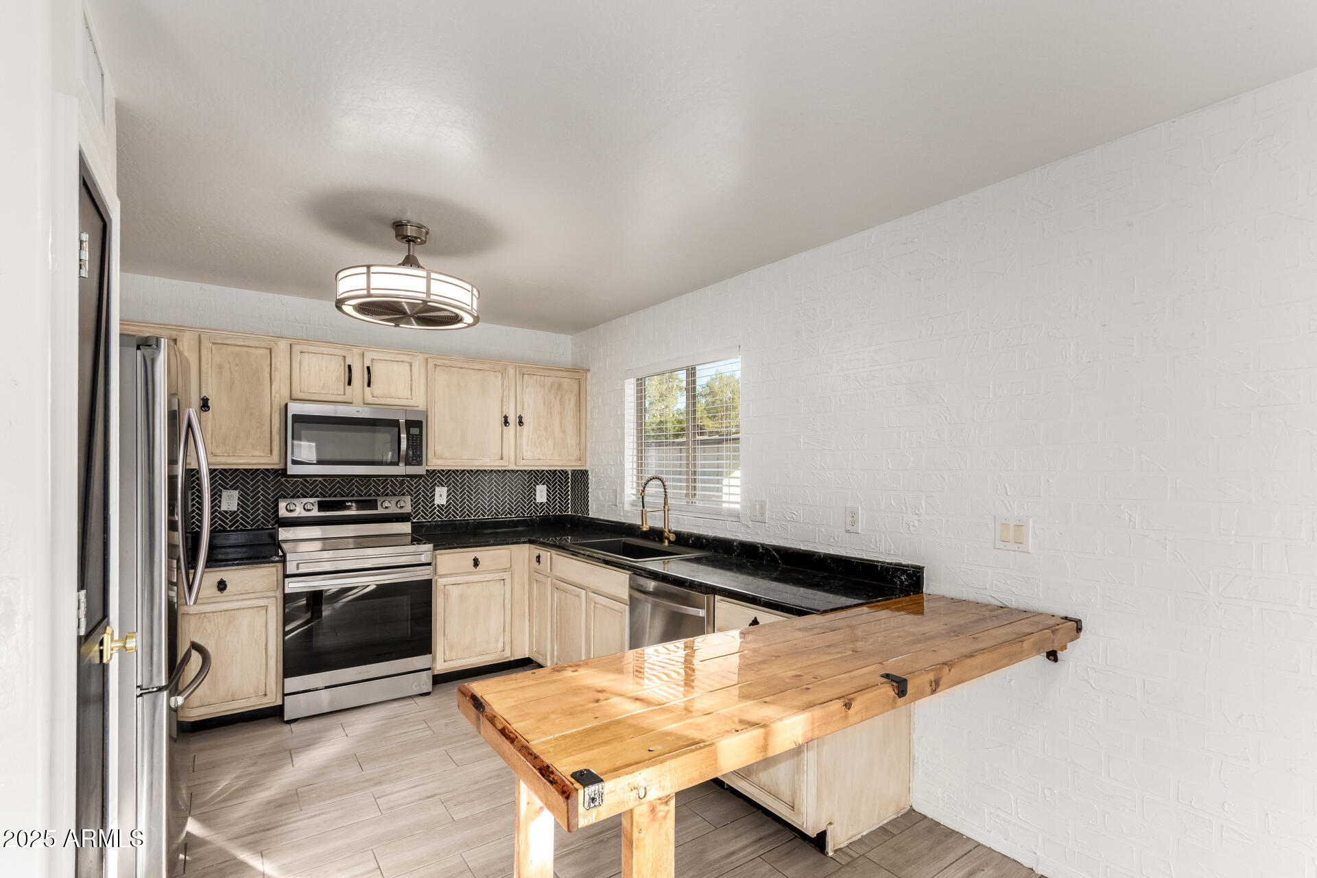 2507 West Desert Spring Way San Tan Valley, AZ 85144 - Photo 6 of 24 a kitchen with granite countertop a sink cabinets and stainless steel appliances