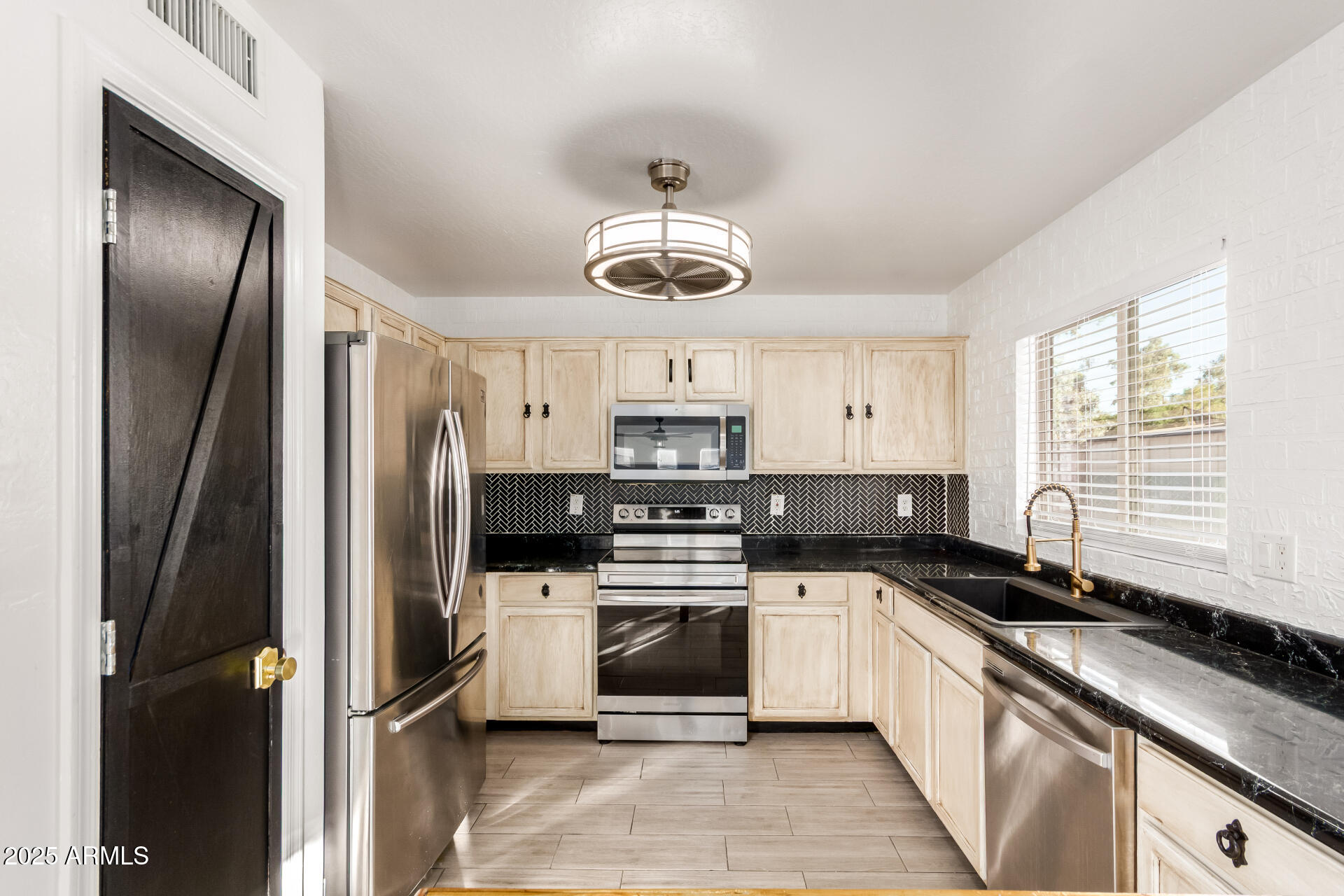 2507 West Desert Spring Way San Tan Valley, AZ 85144 - Photo 7 of 24 a kitchen with stainless steel appliances a refrigerator sink and cabinets
