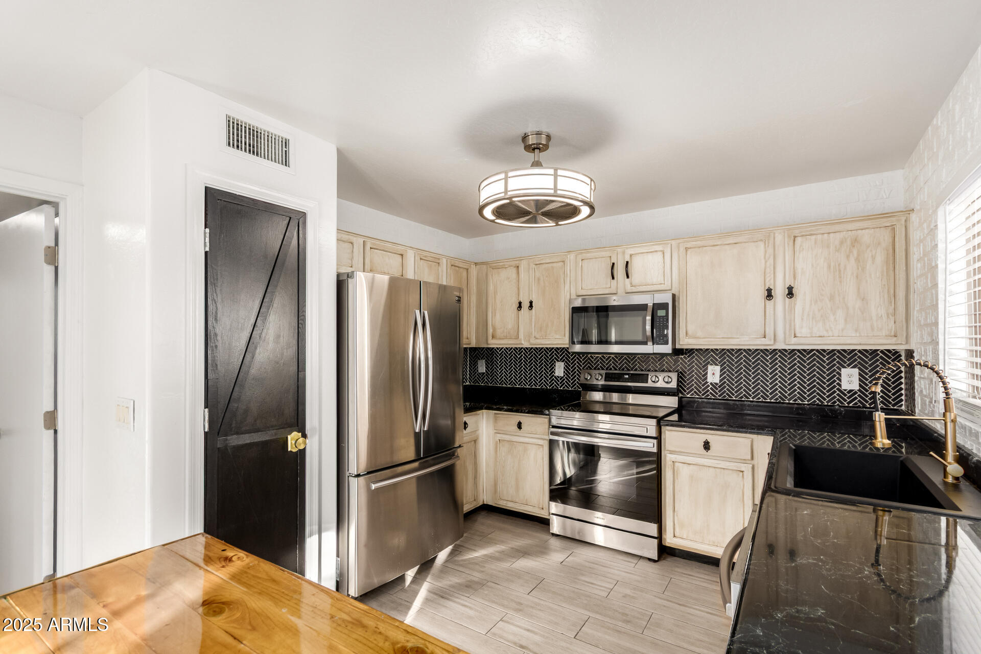 2507 West Desert Spring Way San Tan Valley, AZ 85144 - Photo 8 of 24 a kitchen with a refrigerator and a sink
