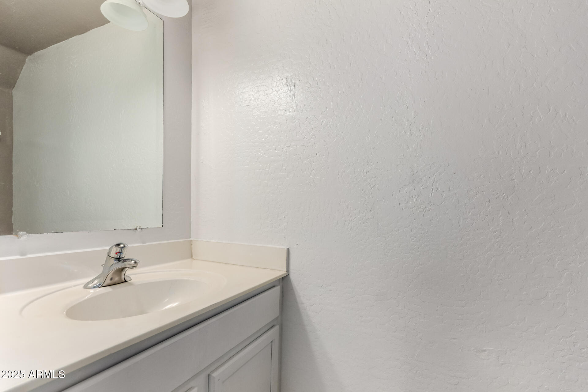 2507 West Desert Spring Way San Tan Valley, AZ 85144 - Photo 10 of 24 a bathroom with a sink and a mirror