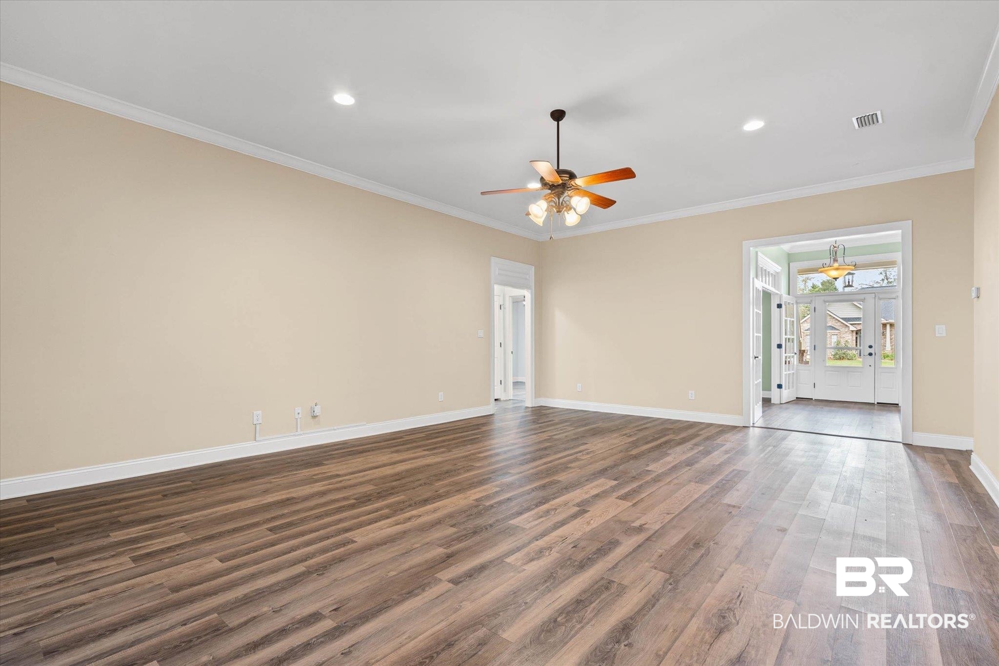 704 Edinburgh Avenue Foley, AL 36535 - Photo 7 of 32 Unfurnished living room with crown molding, dark wood-type flooring, recessed lighting, and a ceiling fan
